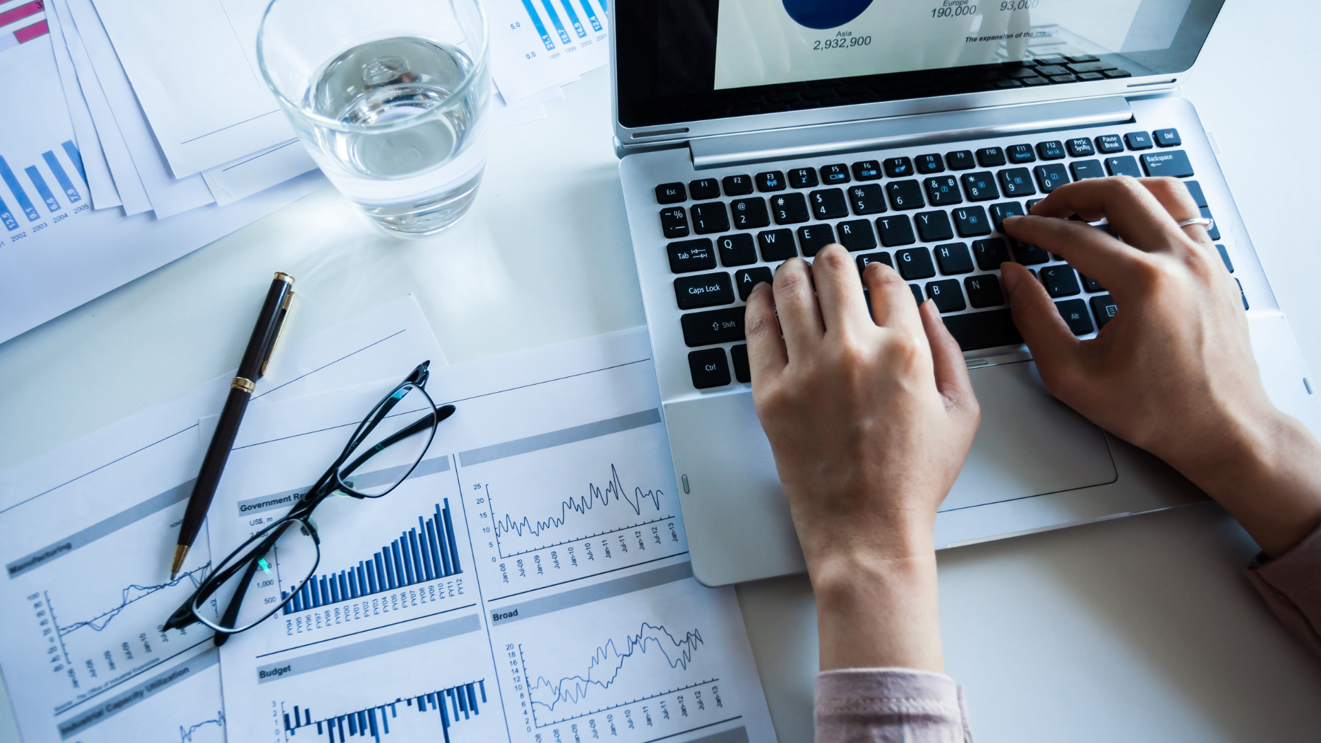 Person working on computer to export workplace reporting
